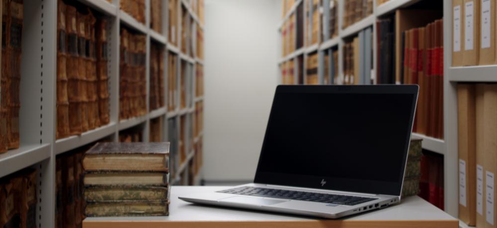 A computer and books on a desk